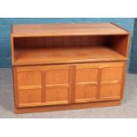 A Teak TV cabinet with lower cupboard. Height: 76cm, Width: 102cm, Depth: 44cm.