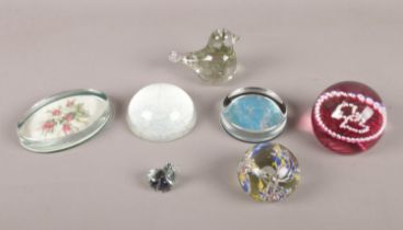 An assortment of seven glass paperweights/dumps.