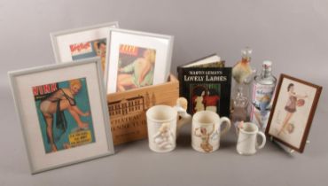 A wooden box containing a selection of erotic objects. To include three ceramic mugs with nude