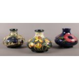 Three Moorcroft squat pottery vases. 12cm height.