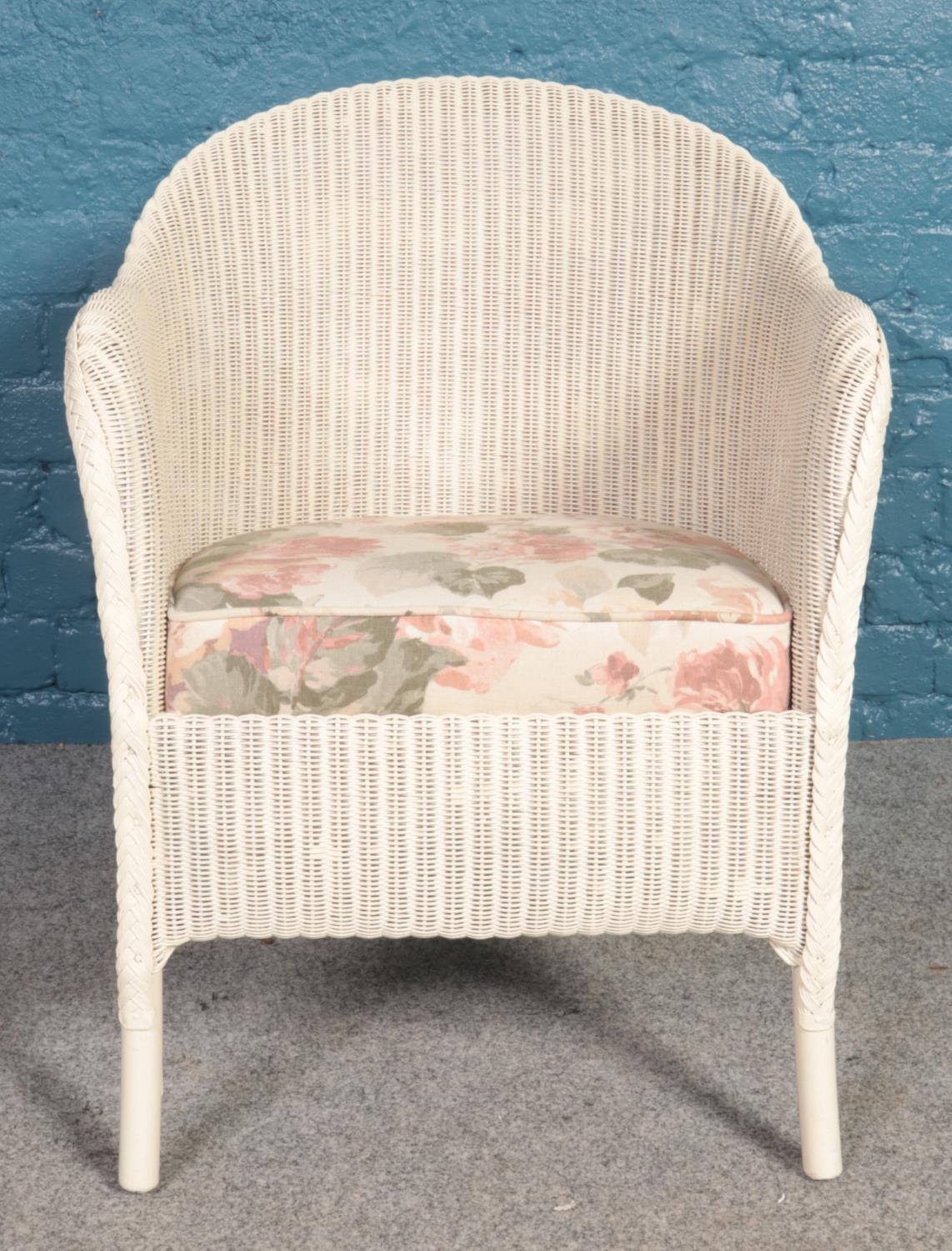 A Lloyd Loom Lusty white chair with floral seat cushion. H: 74cm, W:51.5cm, D: 43cm. - Image 2 of 4