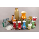 A large quantity of coloured art glass. Including vases, pedestal bowl, drinking glasses, etc.