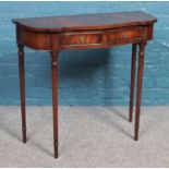 A mahogany demi lune side table with two drawers. Dimensions: Height: 73cm, Width: 80cm.