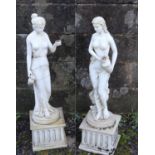 A pair of marble composite garden statues. Formed as semi nude maidens carrying water vessels. (