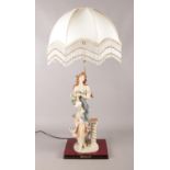 A large ceramic figural table lamp, with frilled cream shade. From the Juliana Collection, stamped