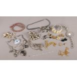 A tin of costume jewellery. Includes silver bracelet, cufflinks, yellow metal albert chain etc.