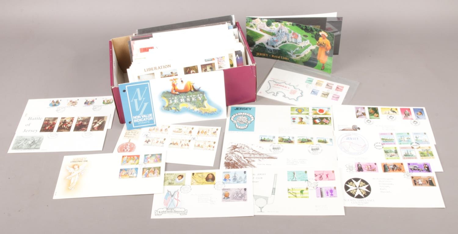 A box of 1st day covers from Jersey, together with mint stamp sets. Approx. 170 in total.