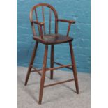 A vintage child's wooden high chair. 84cm height 35cm width.