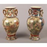Two oriental ceramic vases, with gilt, floral and beaded decoration. Stamped to the base. Height: