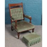 A mahogany armchair with green deep buttoned upholstery along matching footstool.