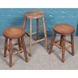 A pair of turned mahogany stools along with another taller stool.