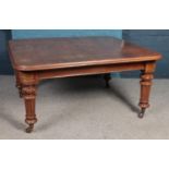 A Victorian wind out oak table (missing winder) with carved legs, raised on casters. Height: 74cm,
