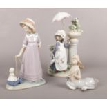 Three Lladro figurines. Girl with parasol, girl with toy, etc