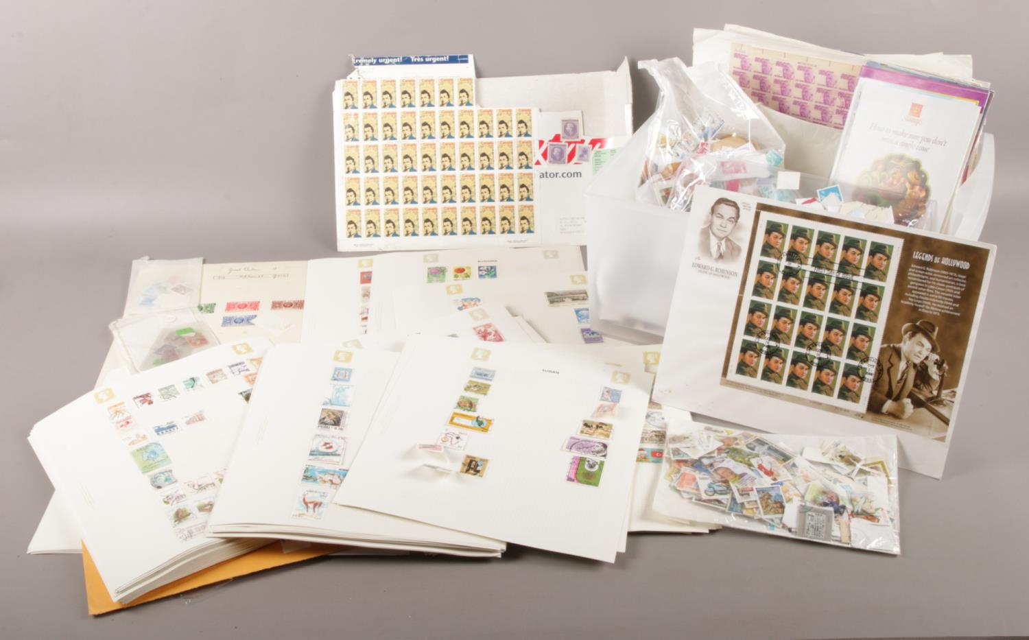 A box containing an extensive selection of UK and World stamps in mint and used states along with