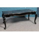 A black and gold lacquered oriental low table, on cabriole legs. Height: 41cm, Width: 95cm, Depth: