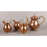 A four piece copper and brass coffee set, with floral decoration to feet and handles. To include