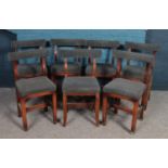 A set of seven oak framed and upholstered chairs with curved back rest. H: 73.5cm, W: 33cm, D: