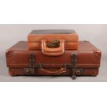 A large 'Revelation' suitcase, stamped with the initials W. H. B, together with a small leather