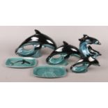 Six pieces of Poole ceramics. To include a set of three graduated dolphins (largest 28cm nose to