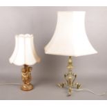 A gilt cherub table lamp along with an ornate brass example.