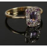 An amethyst and diamond cluster ring. Tests to 18ct Gold. Size P. Total weight: 3.48g Chip to centre