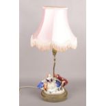 A ceramic figural table lamp. Formed as a courting couple. (76cm)