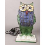 A glass lead glazed table lamp formed as a owl perched on a book. Working.