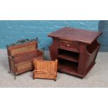 A decorative magazine rack along with a letter rack and wooden side unit.