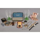 A tray of assorted collectables. To include a series of lighters (including Calibri), ladies dress