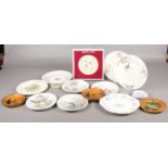 A box of named ceramic plates. To include four Royal Worcester bird plates, a boxed Royal Albert