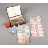 A hardwood box containing a selection of UK and World coinage and notes. To include a Victorian
