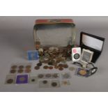 A tin of assorted UK and World coins etc. To include a 50 pence with Paddington bear on the