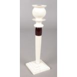 An ivory candlestick with bakelite collar, circa 1920s. 20cm. Scorch to candle holder. Split to
