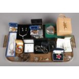 A tray of assorted costume jewellery. To include a Coalport boxed brooch, bone china brooches/