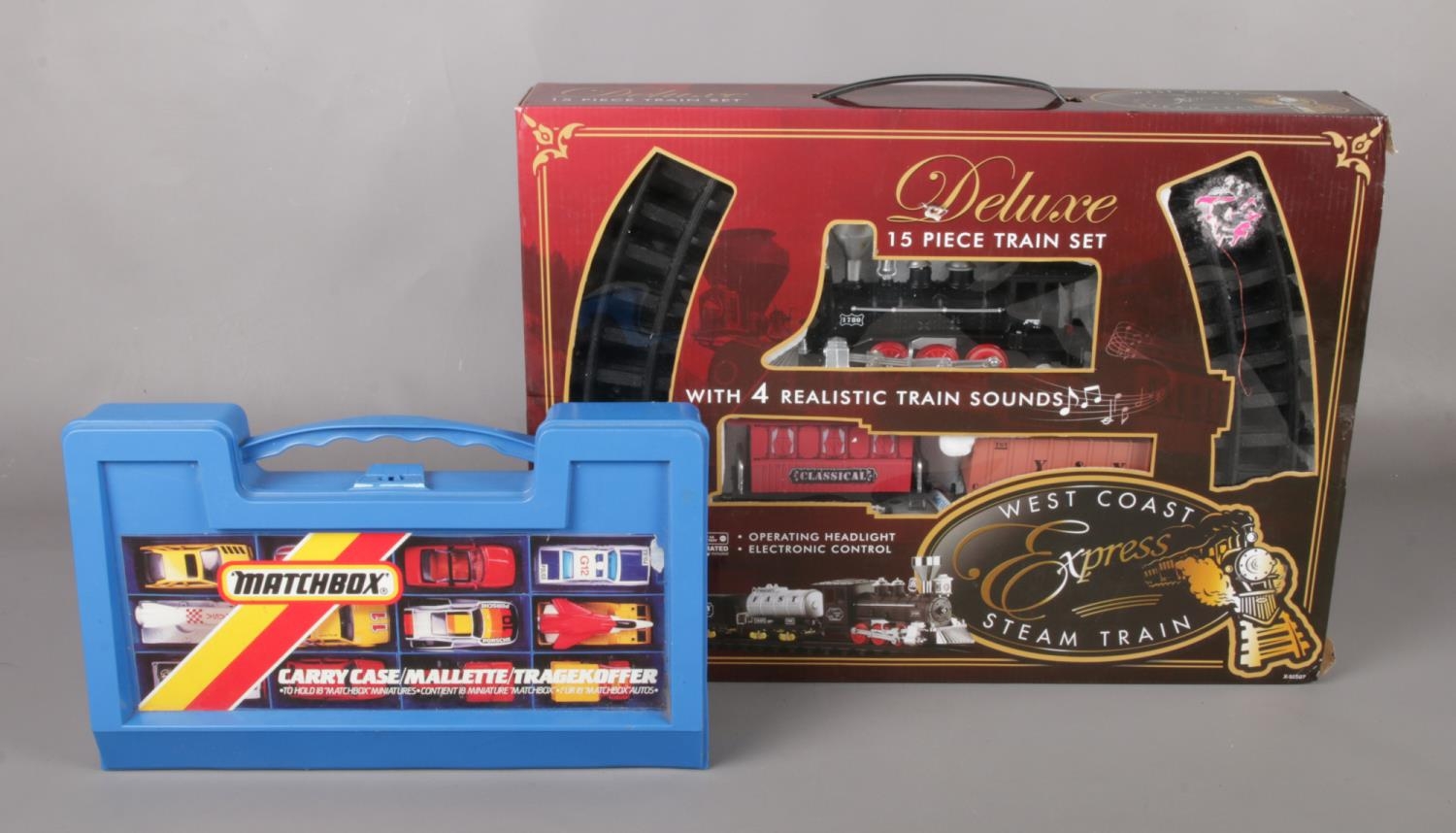 A Matchbox carry case containing 18 cars, together with 15 piece deluxe train set.