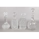 Four cut glass decanters with stoppers.