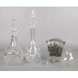 An assortment of glassware. To include two cut glass decanters with stoppers, an etched vase with