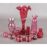 A collection of cranberry glass. Includes Victorian examples.