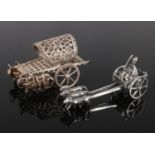 Two white metal miniatures. One modelled as dogs pulling a cart, the other as elephants pulling a