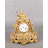 An ornate French gilt metal mantel clock. Mounted with a fisherman. (30cm)