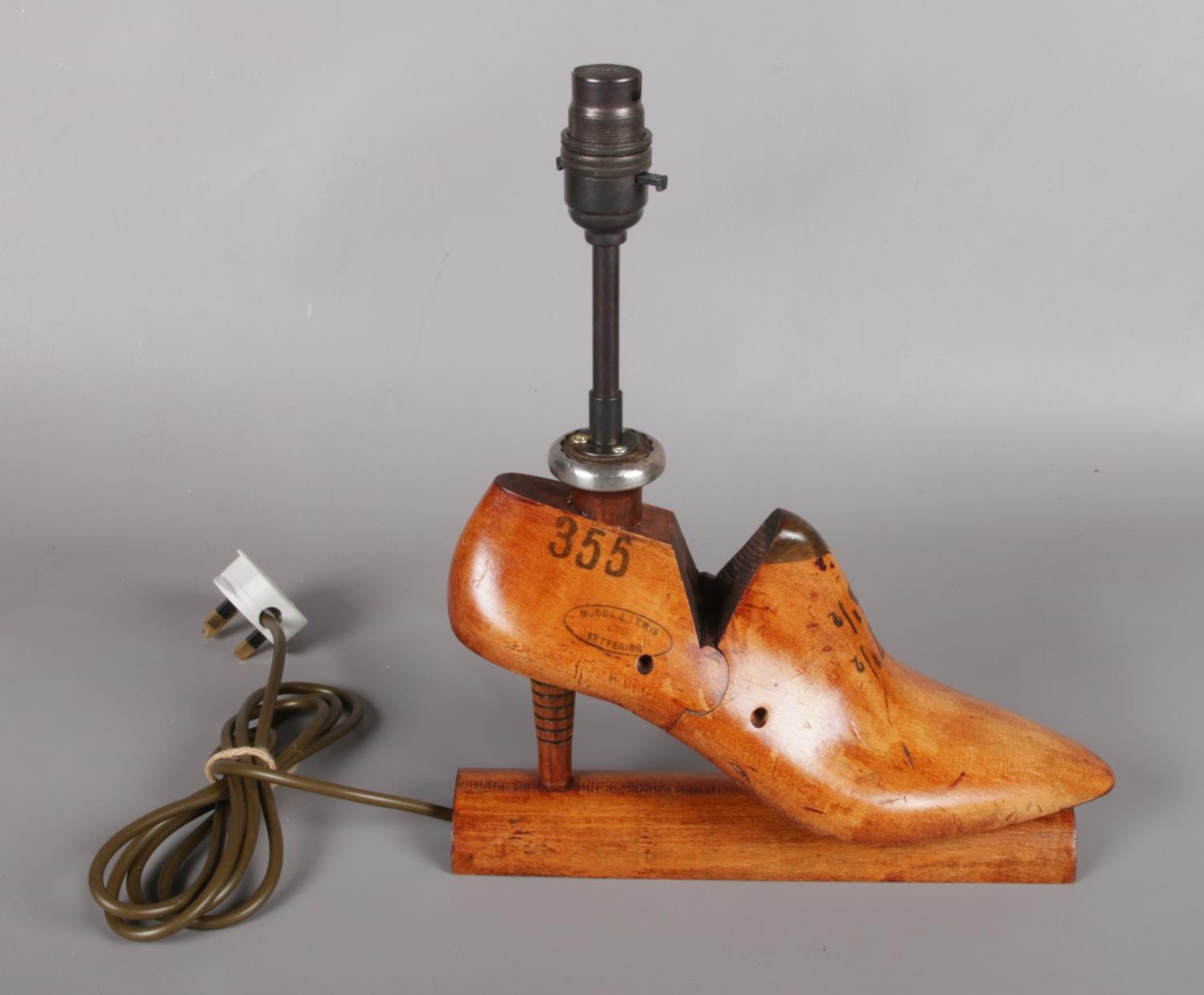 A novelty Mobbs & Lewis Ltd shoe stretcher table lamp.