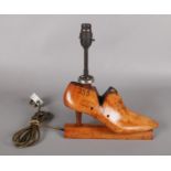 A novelty Mobbs & Lewis Ltd shoe stretcher table lamp.