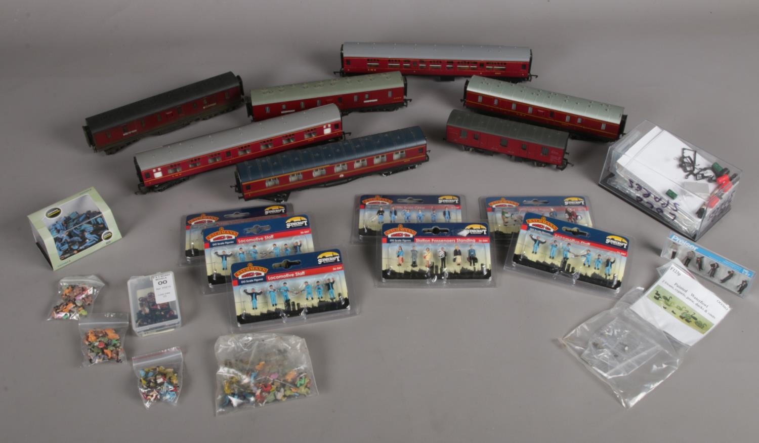 A box of assorted 00 gauge carriages and boxed figures etc. To include seven carriage (Hornby,