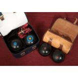 Two sets of Henselite lawn bowls.