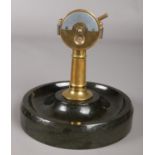 A German novelty cigar cutter in the form of a ships telegraph, with slate ash tray base.