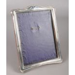 A silver mounted easel photograph frame. Assayed Birmingham 1924 by Green & Cadbury Ltd. Some