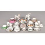 A collection of ceramics, mainly miniatures. Includes Basil Matthews, cups and saucers, crested ware