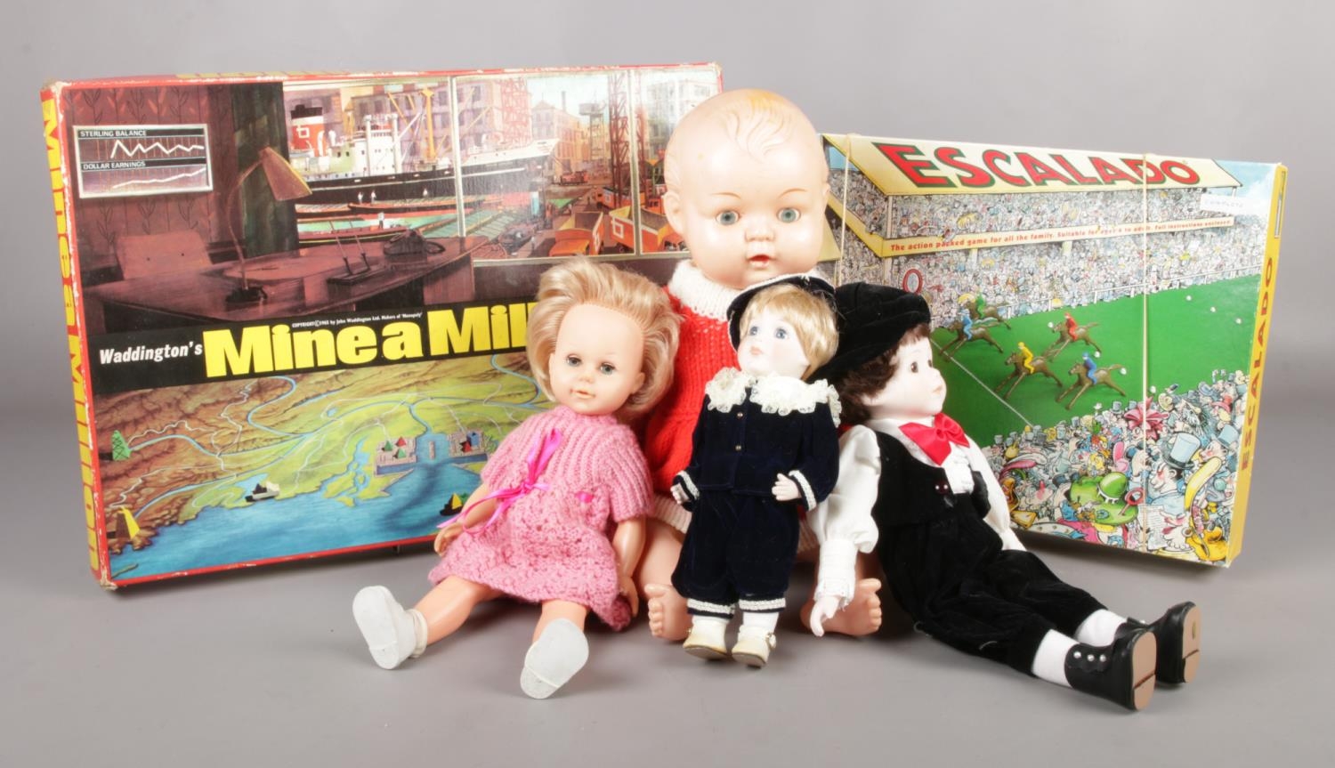 Two vintage games with four vintage dolls. To include Waddington's 'Mine-a-million' & 'Escalado'