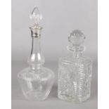 Two glass decanters. Includes one early 20th century example with silver collar, assayed