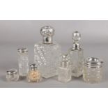 A collection of silver mounted glass jars, scent bottles, hair tidy etc.